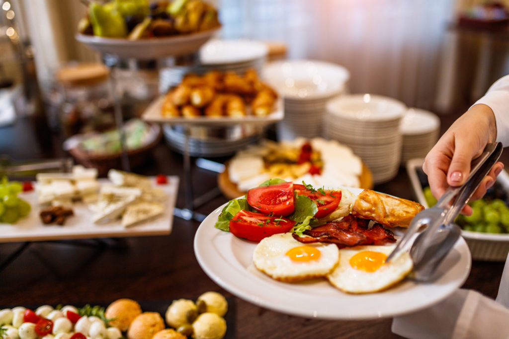 Choosing breakfast at brunch buffet Choosing breakfast at brunch buffet
